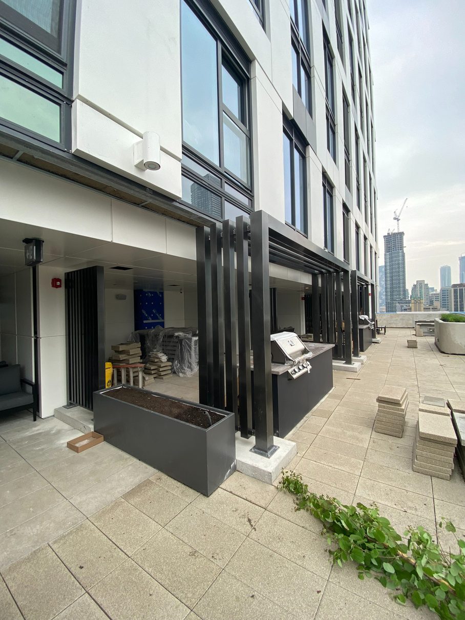 Black steel fin canopy on a modern commercial building entrance