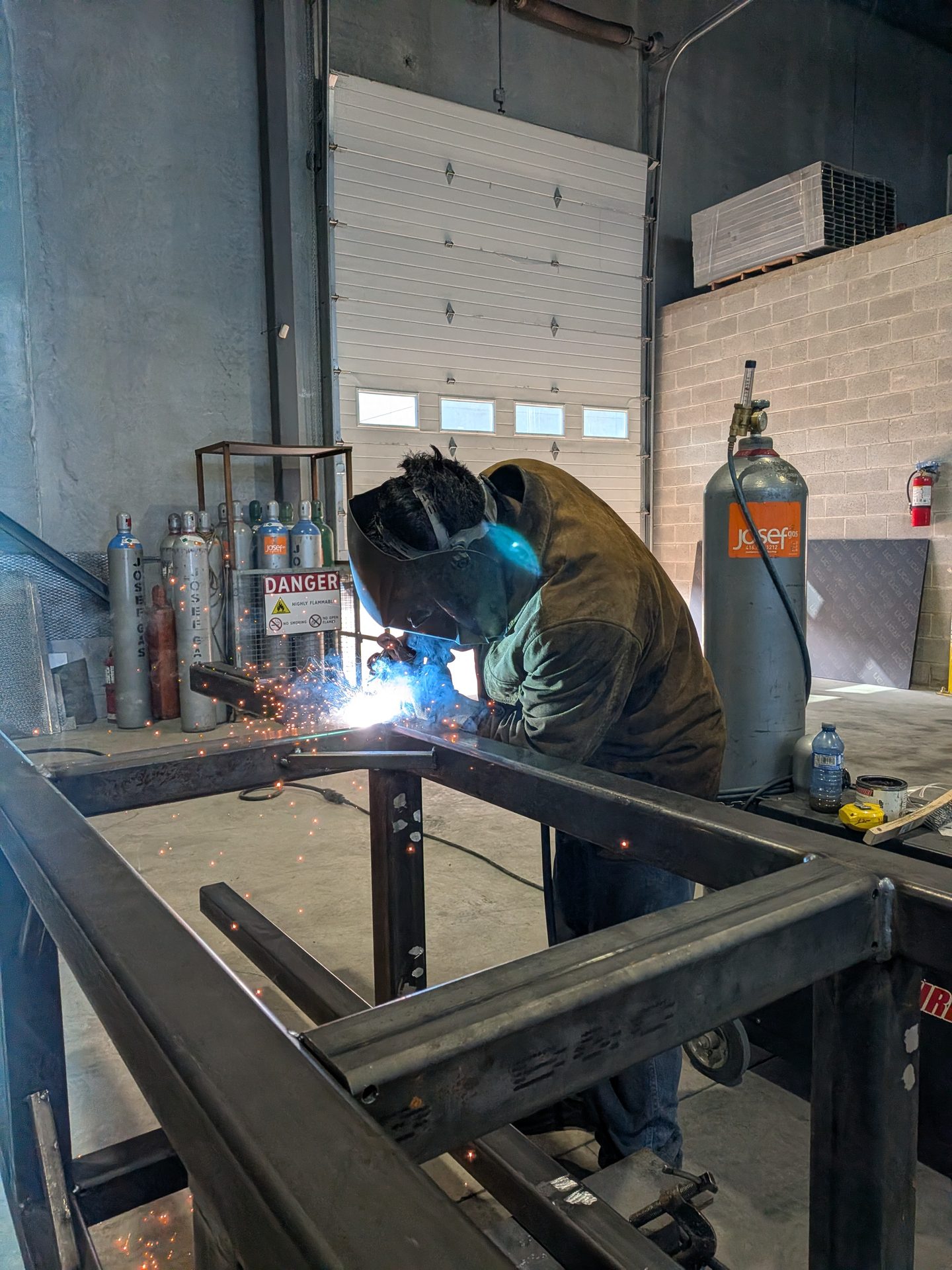 Fabricator welding a structural steel frame in the shop